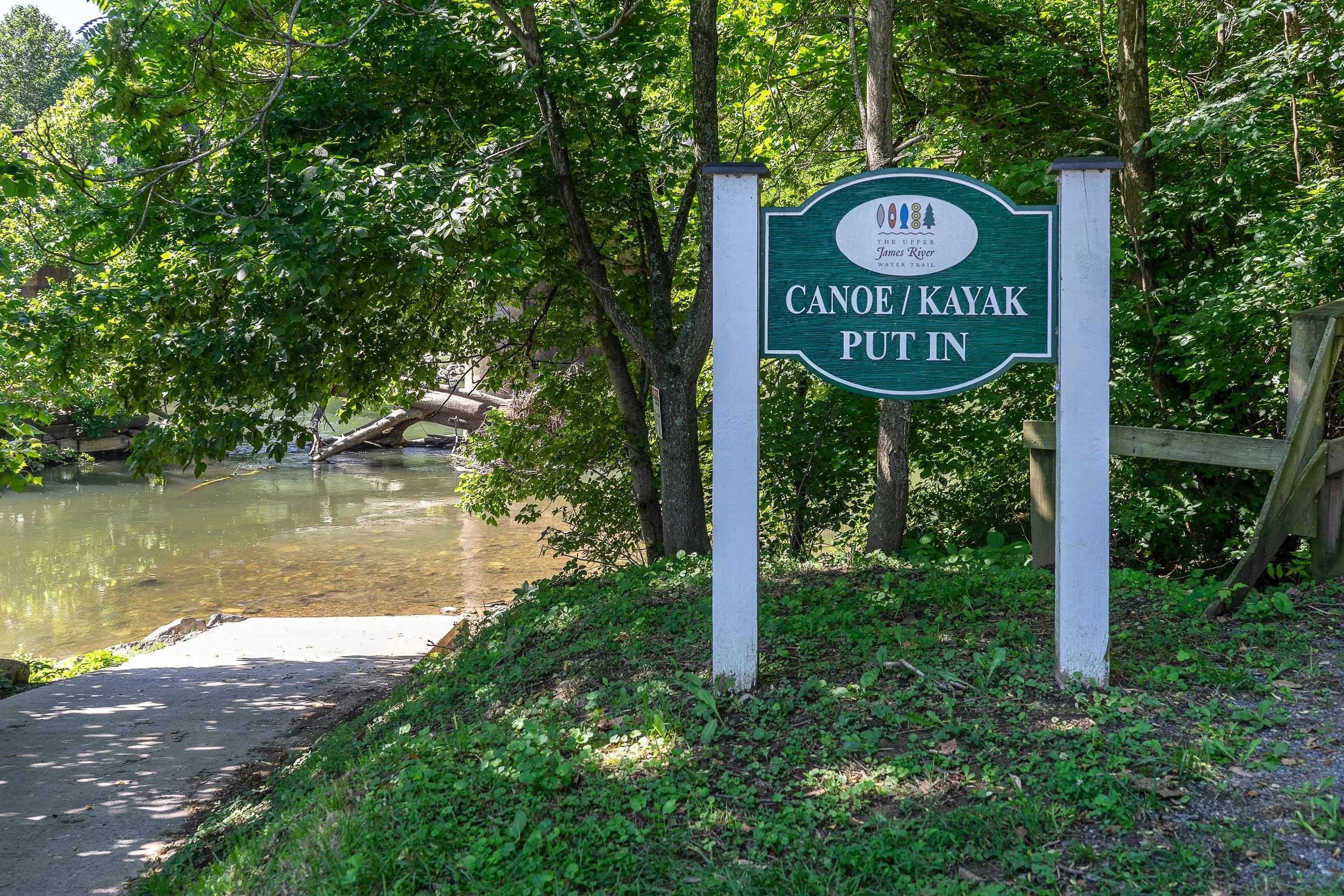 A "Kayak Launch" sign at the river's edge with the Maury River flowing past forested banks beyond.