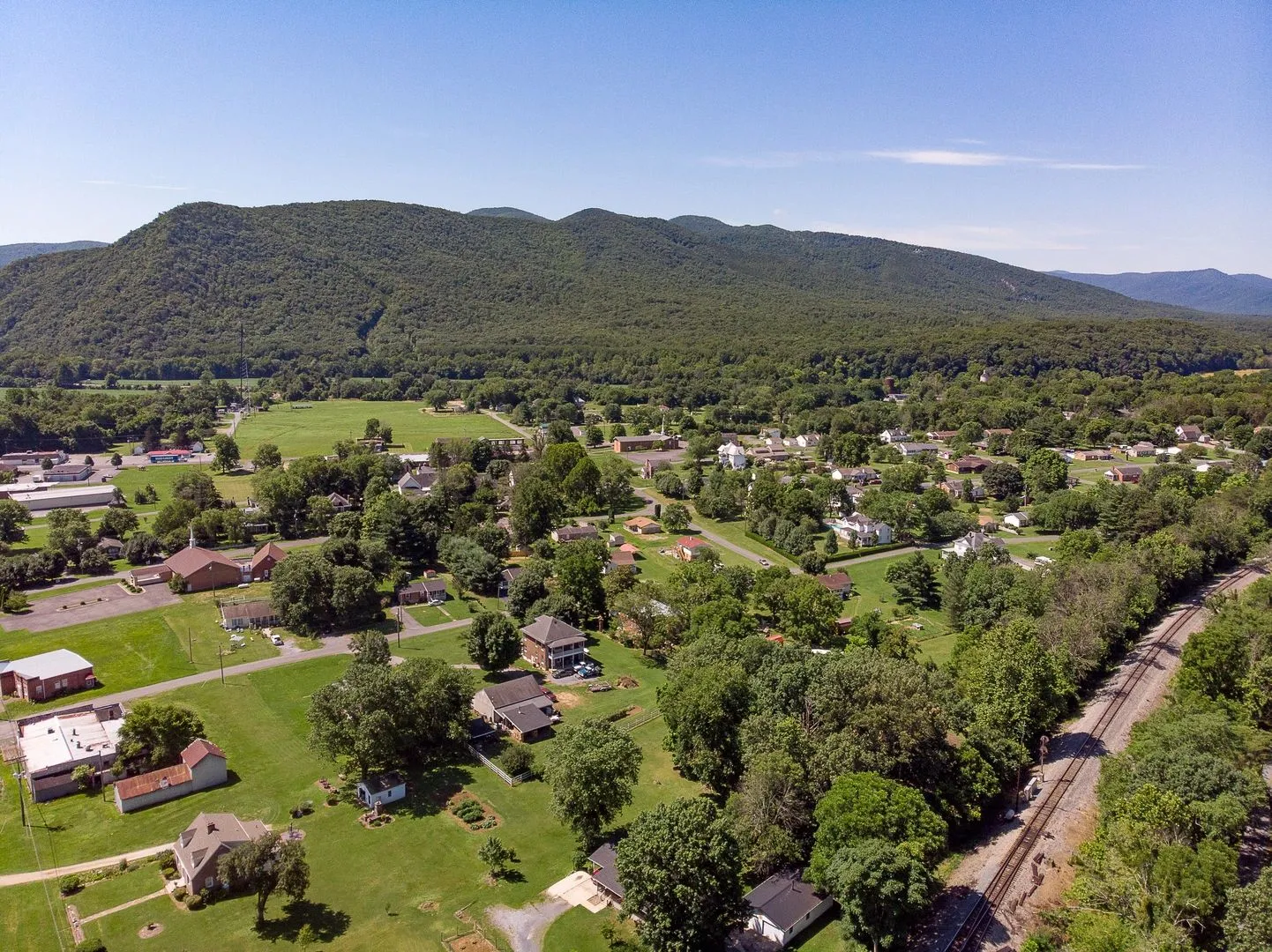The town of Glasgow seen from above on a summer afternoon with the full Blue Ridge as a backdrop.